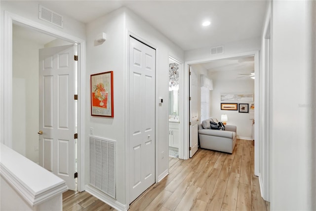 corridor featuring light hardwood / wood-style floors