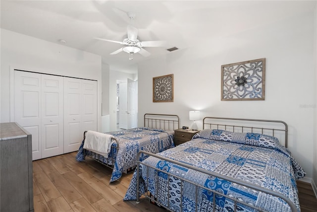 bedroom with a closet, ceiling fan, and wood-type flooring