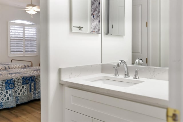 bathroom featuring hardwood / wood-style floors, ceiling fan, and vanity