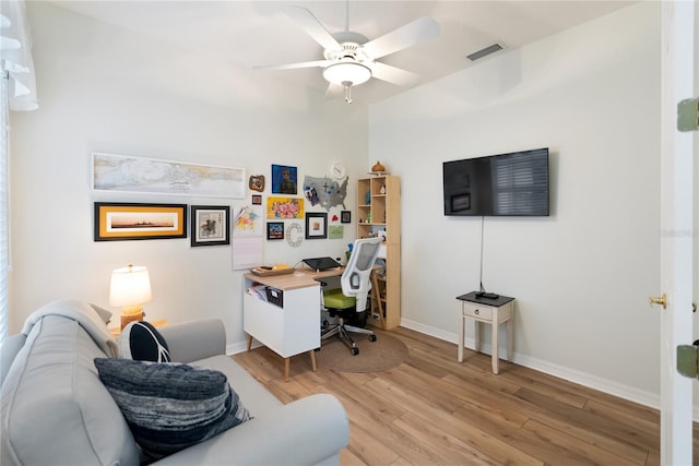 home office featuring light wood-type flooring and ceiling fan