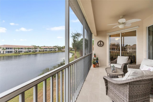 sunroom / solarium with a water view and ceiling fan