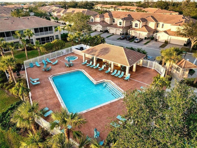 view of swimming pool featuring a patio area and a hot tub