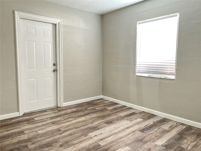 unfurnished room featuring hardwood / wood-style flooring