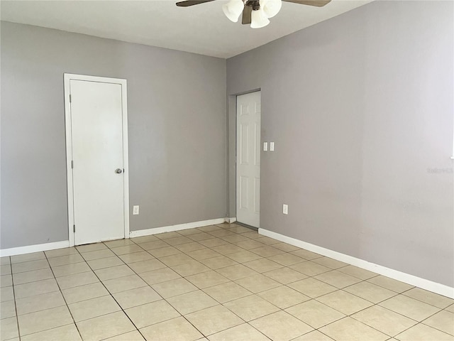 empty room featuring ceiling fan and light tile patterned floors