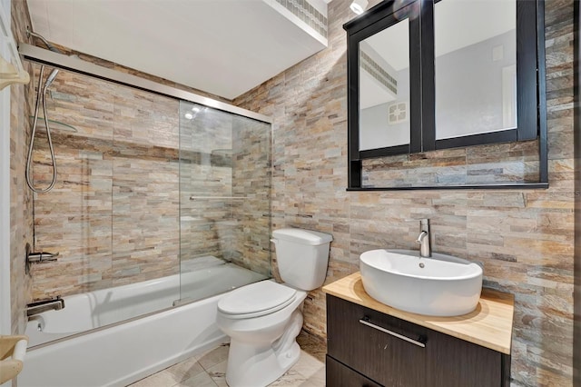 full bathroom featuring enclosed tub / shower combo, vanity, and toilet