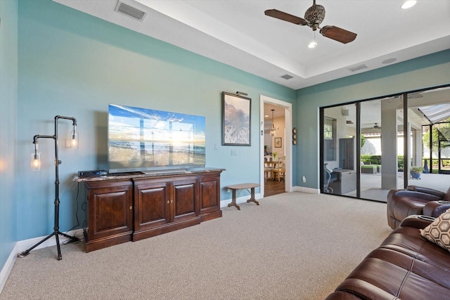 living room with light colored carpet and ceiling fan