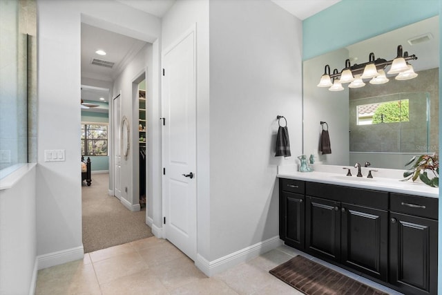 bathroom with crown molding, vanity, and tile patterned floors