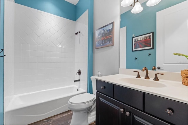 full bathroom featuring vanity, hardwood / wood-style flooring, bathing tub / shower combination, and toilet