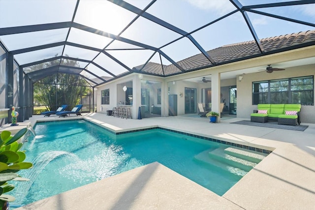 view of swimming pool with a lanai, a patio area, pool water feature, and exterior bar