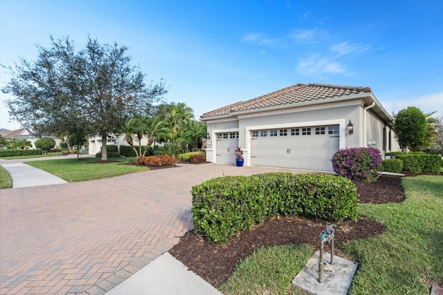 view of front of house with a garage and a front yard