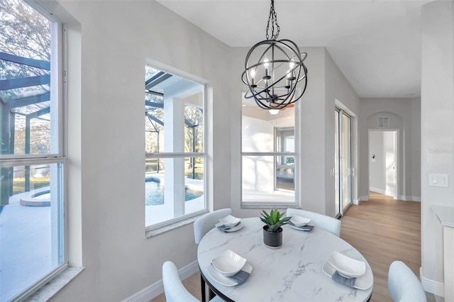 14146 Cattle Egret Pl, Bradenton, FL 34202 - dining space with an inviting chandelier, wood-type flooring, and plenty of natural light