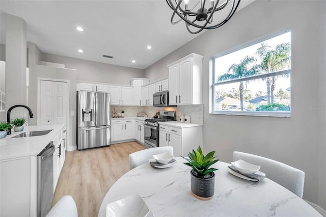 14146 Cattle Egret Pl, Bradenton, FL 34202 - dining area featuring light wood-type flooring, sink, and a chandelier