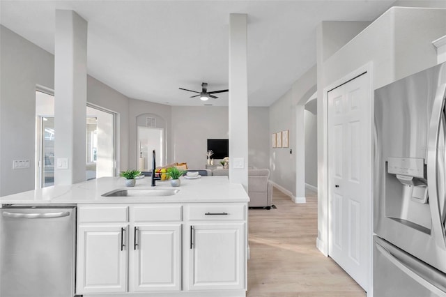 14146 Cattle Egret Pl, Bradenton, FL 34202 - kitchen with ceiling fan, light hardwood / wood-style floors, sink, white cabinetry, and appliances with stainless steel finishes