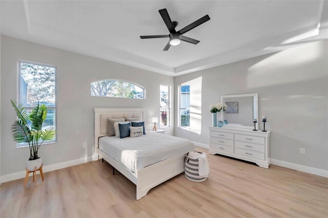 14146 Cattle Egret Pl, Bradenton, FL 34202 - bedroom with ceiling fan, light wood-type flooring, and a tray ceiling