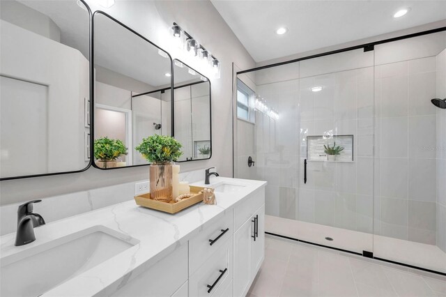 14146 Cattle Egret Pl, Bradenton, FL 34202 - bathroom featuring tile patterned flooring, a shower with shower door, and vanity
