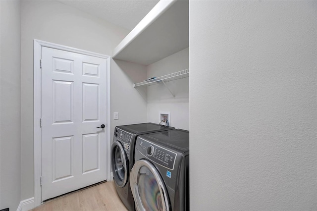 14146 Cattle Egret Pl, Bradenton, FL 34202 - laundry area featuring washer and dryer and light hardwood / wood-style floors