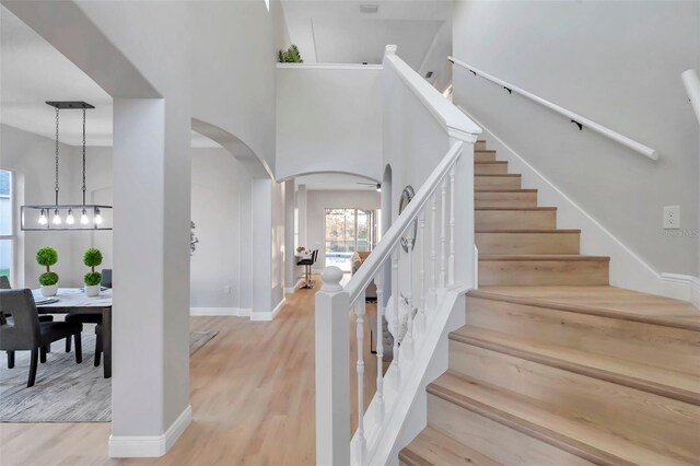 14146 Cattle Egret Pl, Bradenton, FL 34202 - stairway featuring wood-type flooring and a high ceiling
