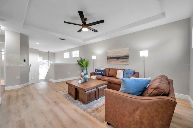 14146 Cattle Egret Pl, Bradenton, FL 34202 - living room with ceiling fan, a tray ceiling, and light hardwood / wood-style floors