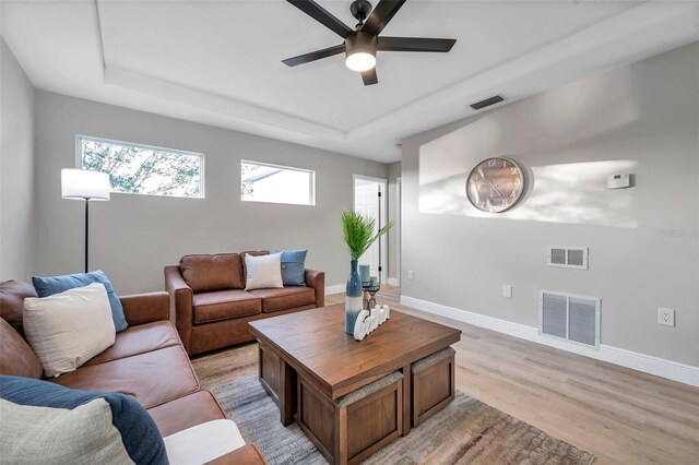 14146 Cattle Egret Pl, Bradenton, FL 34202 - living room featuring light wood-type flooring, ceiling fan, and a raised ceiling
