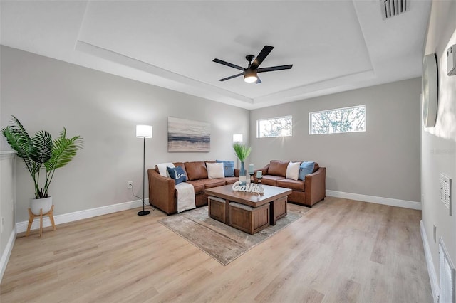 14146 Cattle Egret Pl, Bradenton, FL 34202 - living room featuring ceiling fan, light hardwood / wood-style floors, and a raised ceiling