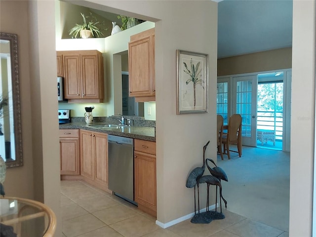 kitchen featuring light tile patterned floors, appliances with stainless steel finishes, light brown cabinets, and sink