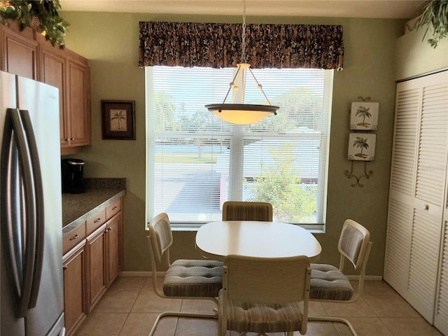 dining area featuring a wealth of natural light and light tile patterned floors