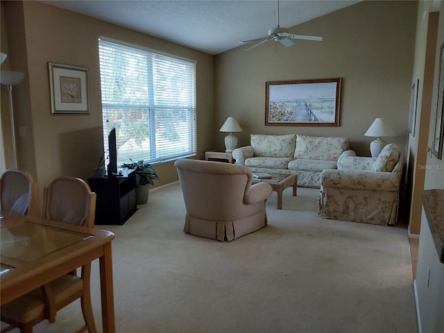 carpeted living room featuring vaulted ceiling and ceiling fan