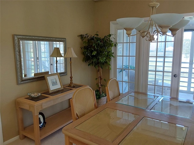 dining room featuring french doors and a notable chandelier