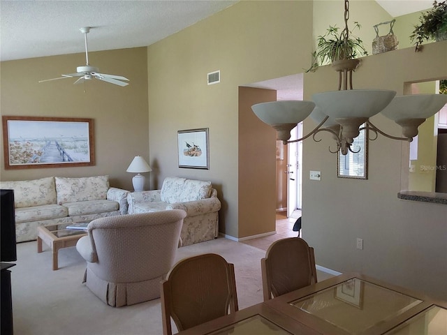 living room with ceiling fan with notable chandelier and light carpet