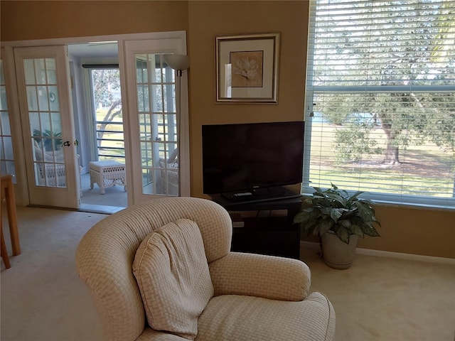 living area with light carpet and french doors