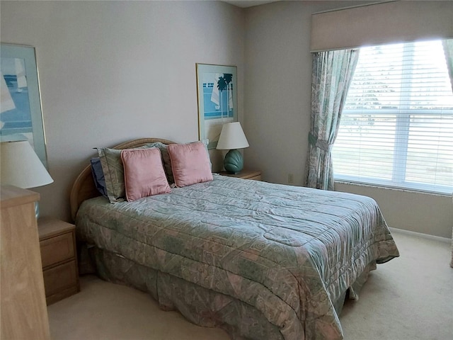 bedroom featuring light colored carpet