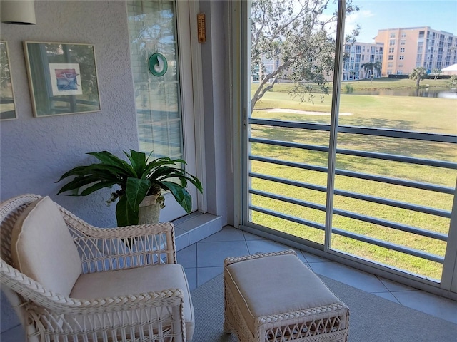 sunroom / solarium featuring plenty of natural light and a water view