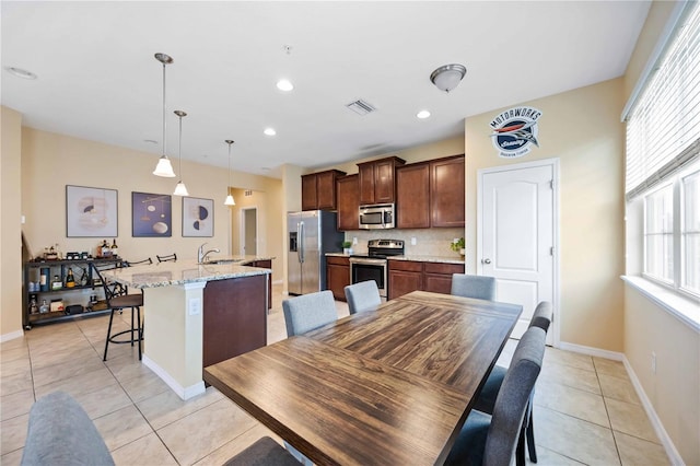 dining room with sink and light tile patterned floors