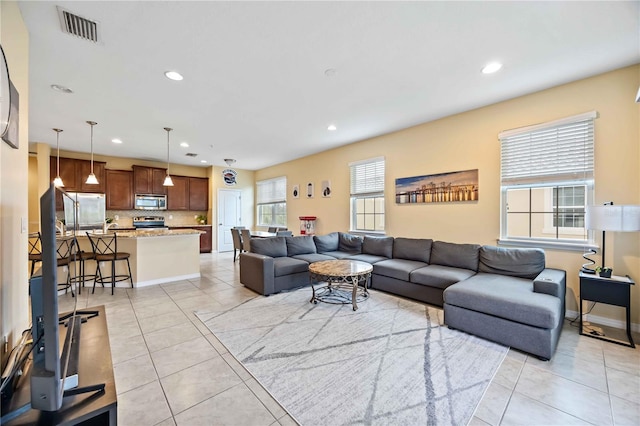 tiled living room featuring a healthy amount of sunlight