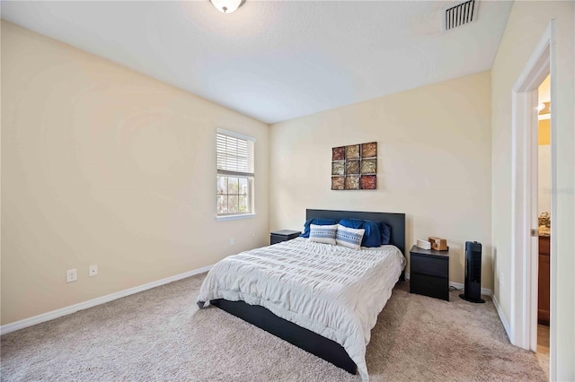 bedroom with light colored carpet