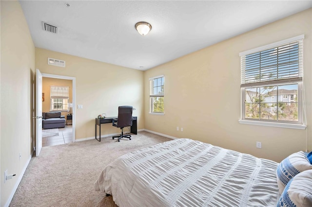 bedroom featuring light colored carpet