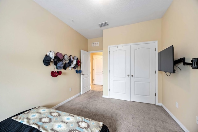 bedroom with carpet and a closet