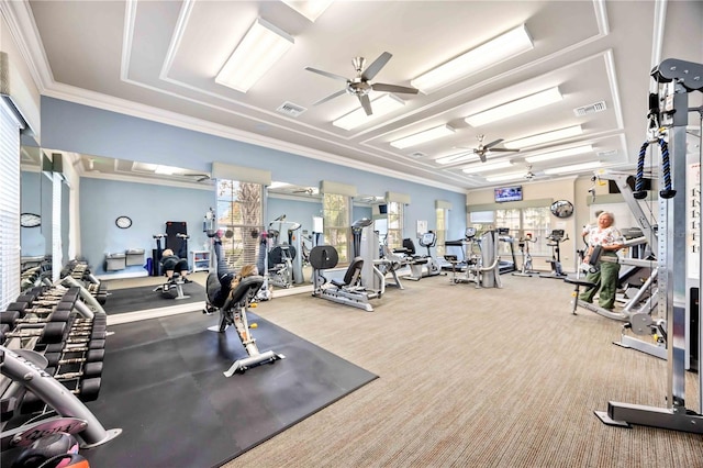 gym with ceiling fan, a healthy amount of sunlight, and crown molding