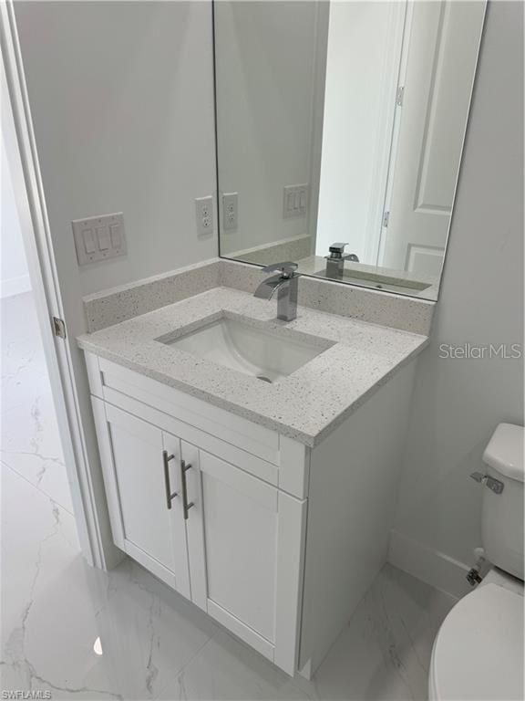 bathroom with toilet and vanity