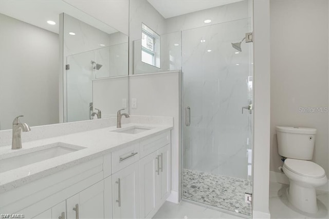 bathroom featuring vanity, toilet, and a shower with shower door