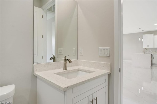 bathroom with vanity and toilet