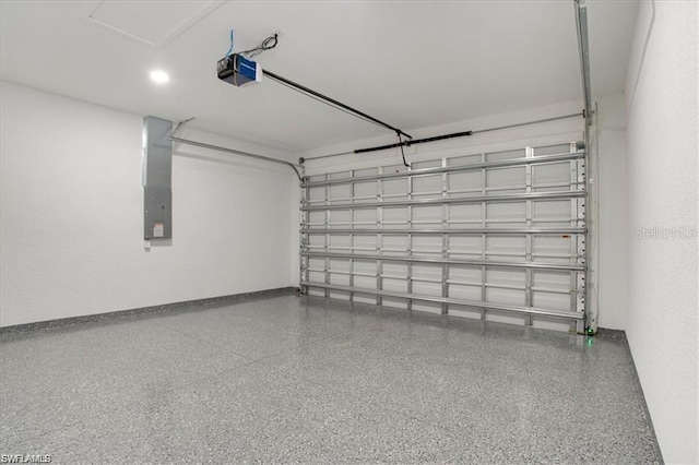 garage featuring electric panel and a garage door opener