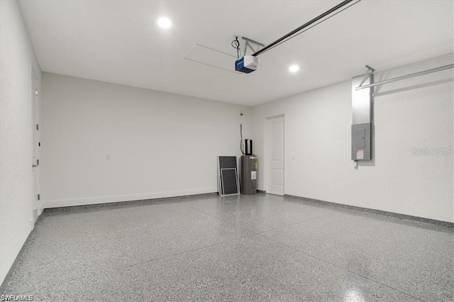 garage with water heater, a garage door opener, and electric panel