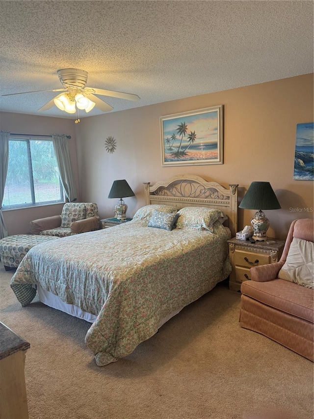 carpeted bedroom with ceiling fan and a textured ceiling