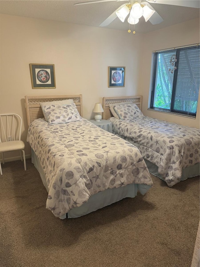 bedroom featuring ceiling fan and carpet