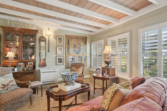 sitting room featuring vaulted ceiling with beams, heating unit, and wood ceiling