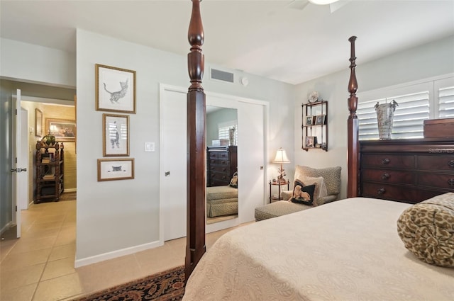 bedroom with ceiling fan and light tile patterned flooring