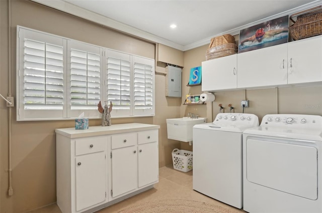 clothes washing area featuring cabinets, washing machine and clothes dryer, a healthy amount of sunlight, and electric panel