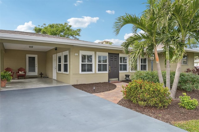 view of exterior entry featuring a carport