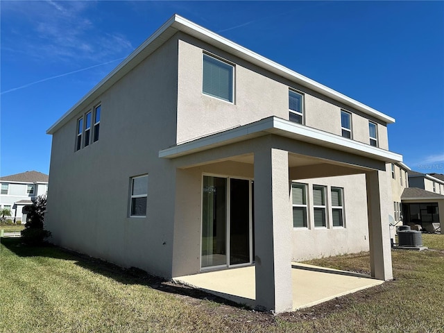 rear view of house featuring a patio and a yard